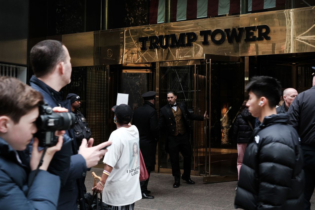 People walk by Trump Tower on March 31 in New York City. 