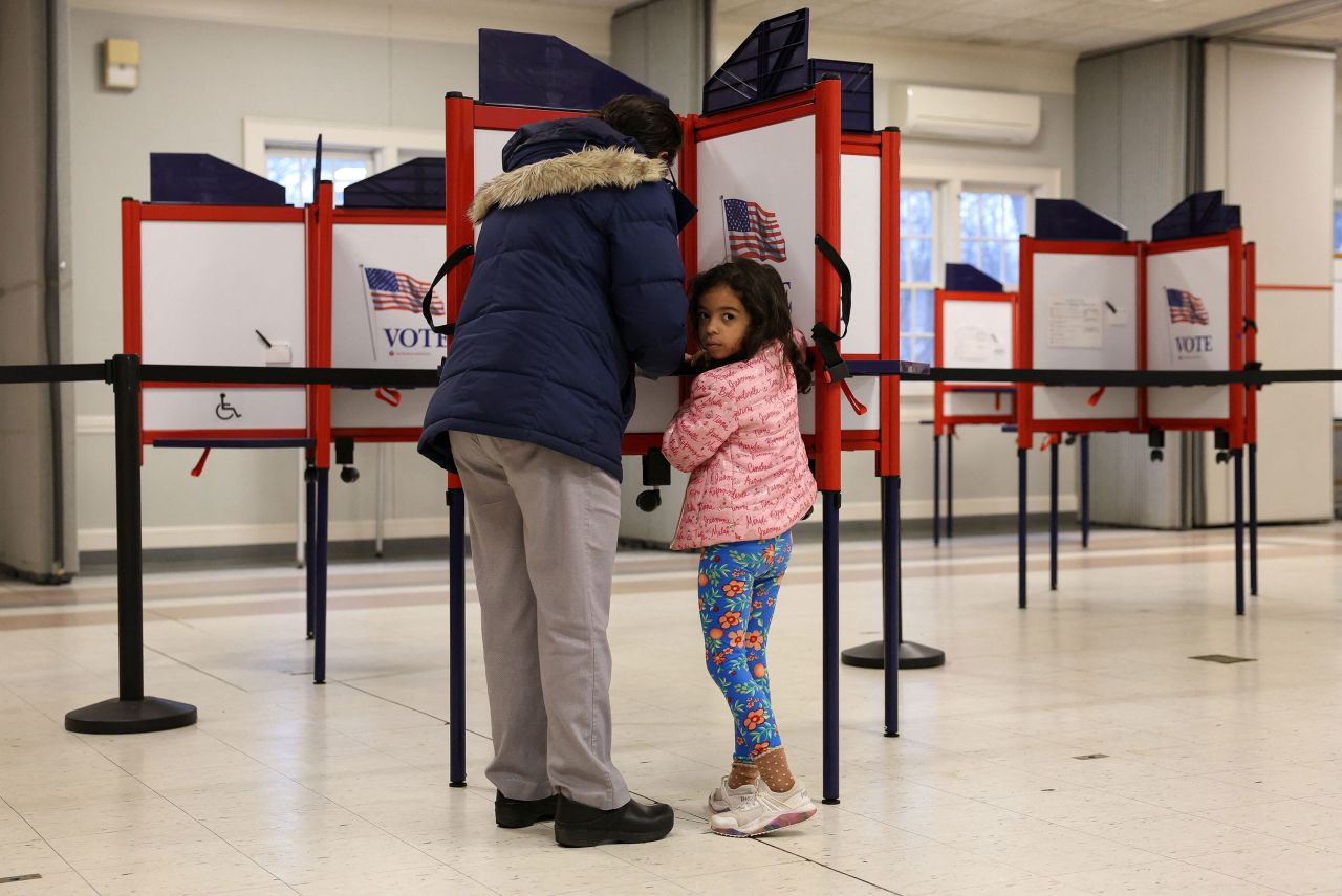 Sophie Townes, 5, looks on as her mother Katie votes during the Super Tuesday primary election in Topsfield, Massachusetts, on March 5.