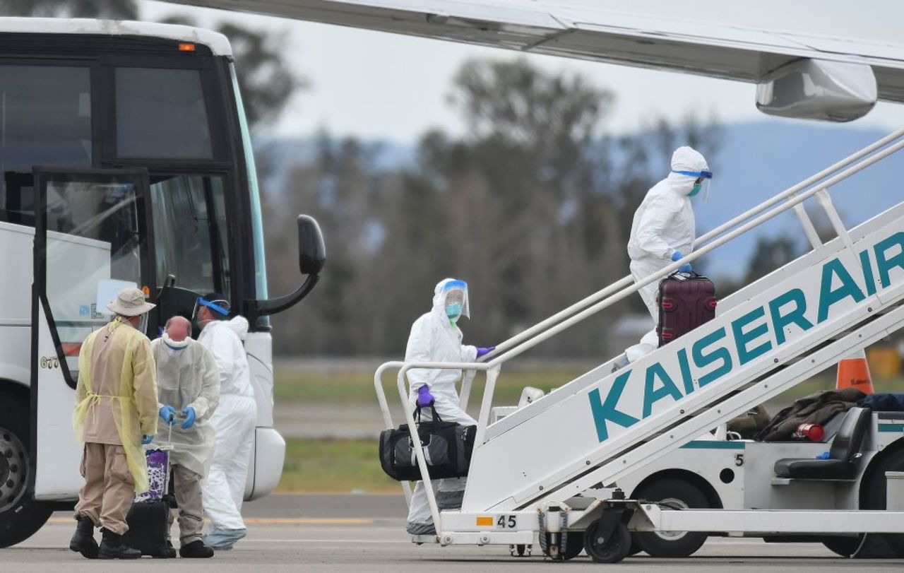 Medical personnel help load passengers from the Grand Princess cruise ship onto airplanes in Oakland, California, on Tuesday. 