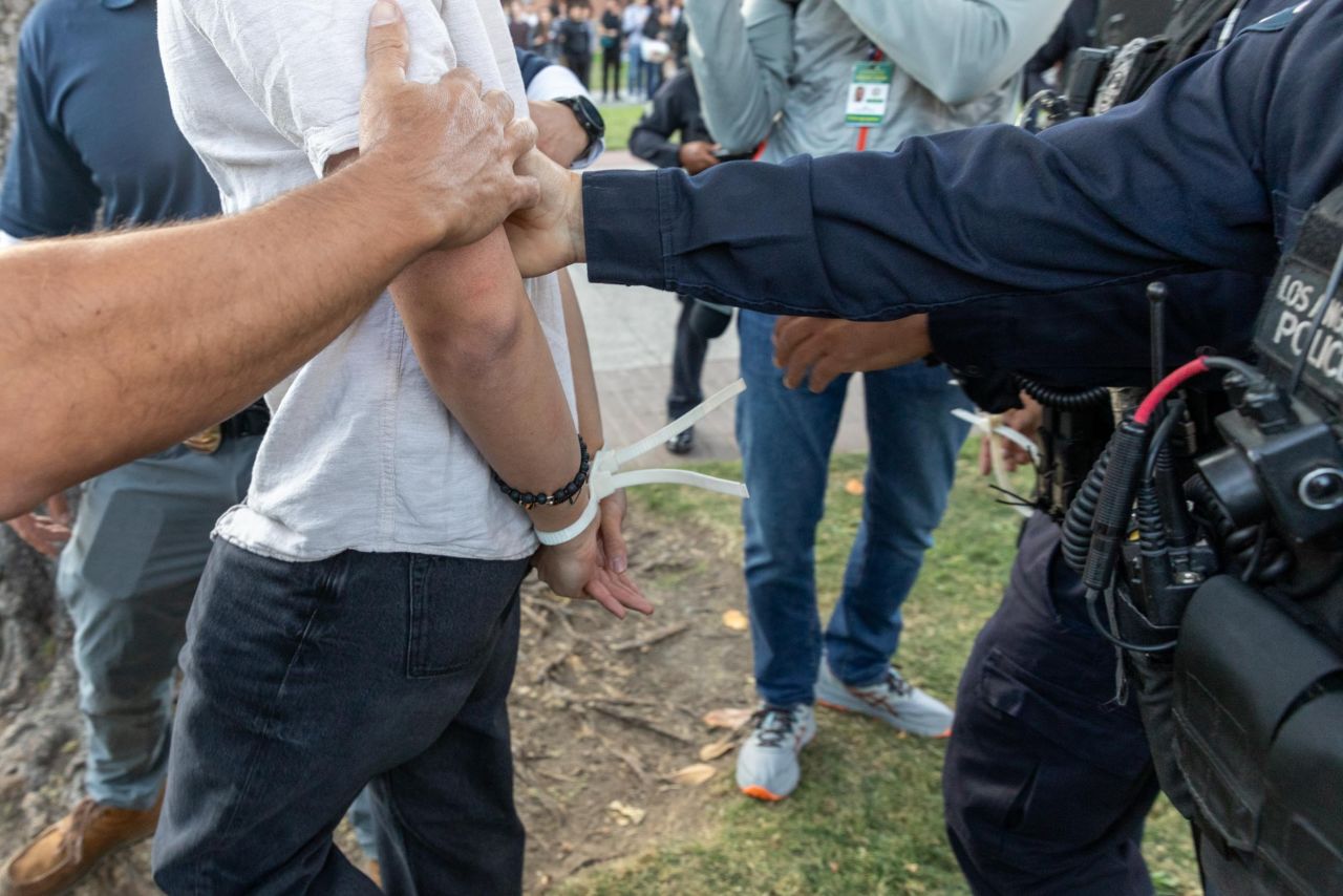 Members of law enforcement and police officers intervene during a pro-Palestinian student protest at the University of Southern California in Los Angeles, California, on April 24. 