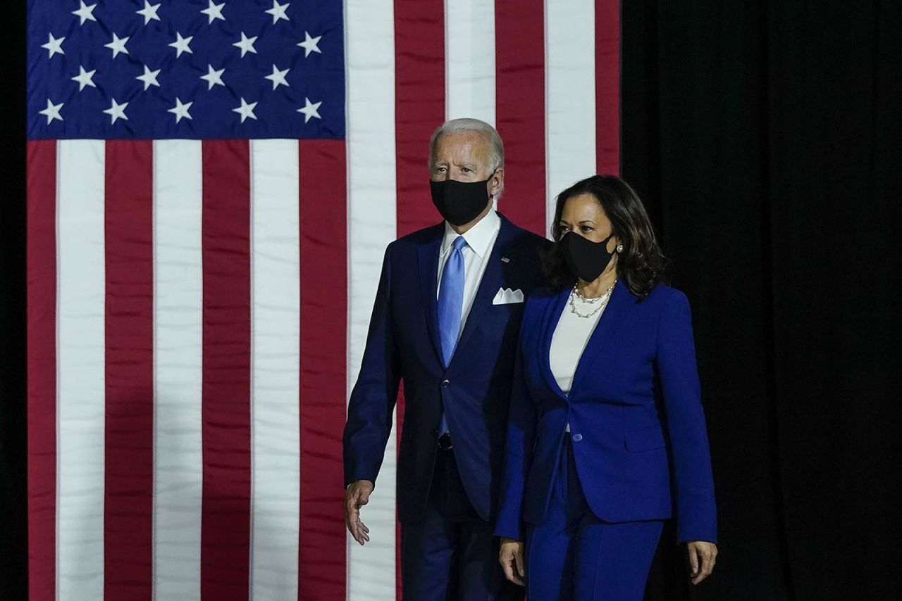 Democratic presidential nominee Joe Biden and his running mate Sen. Kamala Harris arrive to deliver remarks at the Alexis Dupont High School on August 12, in Wilmington, Delaware.