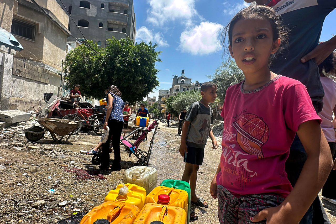 Palestinians wait for water in Deir al-Balah, Gaza, on May 13.