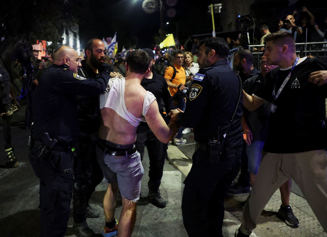 Police members detain a person during a demonstration calling for the immediate return of hostages held in Gaza, near?Israeli Prime Minister Benjamin Netanyahu's residence in Jerusalem, on Monday, September 2.