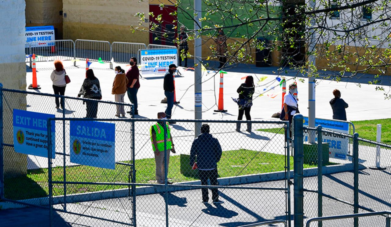 People line up for the first day of Covid-19 vaccinations at a site opened by the Los Angeles Unified School District for employees on February 17 in Los Angeles.