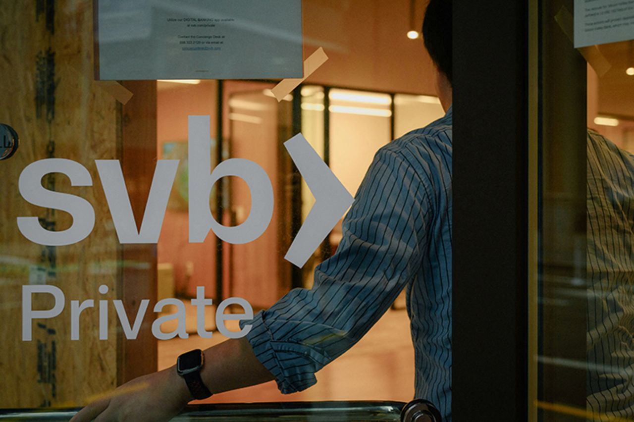 An employee holds the door open at the?Silicon?Valley?Bank?branch office in downtown San Francisco, California, on March 13.