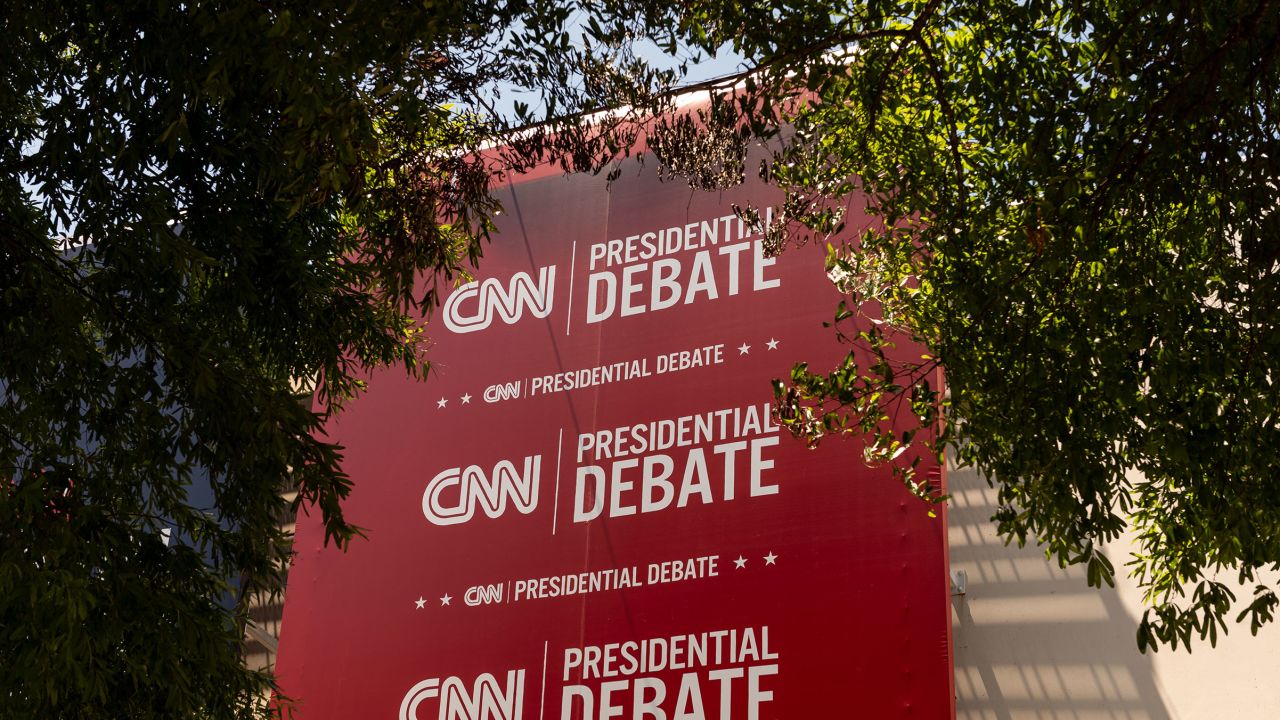 Banners hang outside of CNN’s Atlanta headquarters ahead of CNN’s Presidential Debate between President Joe Biden and former President Donald Trump on Monday, June 24.