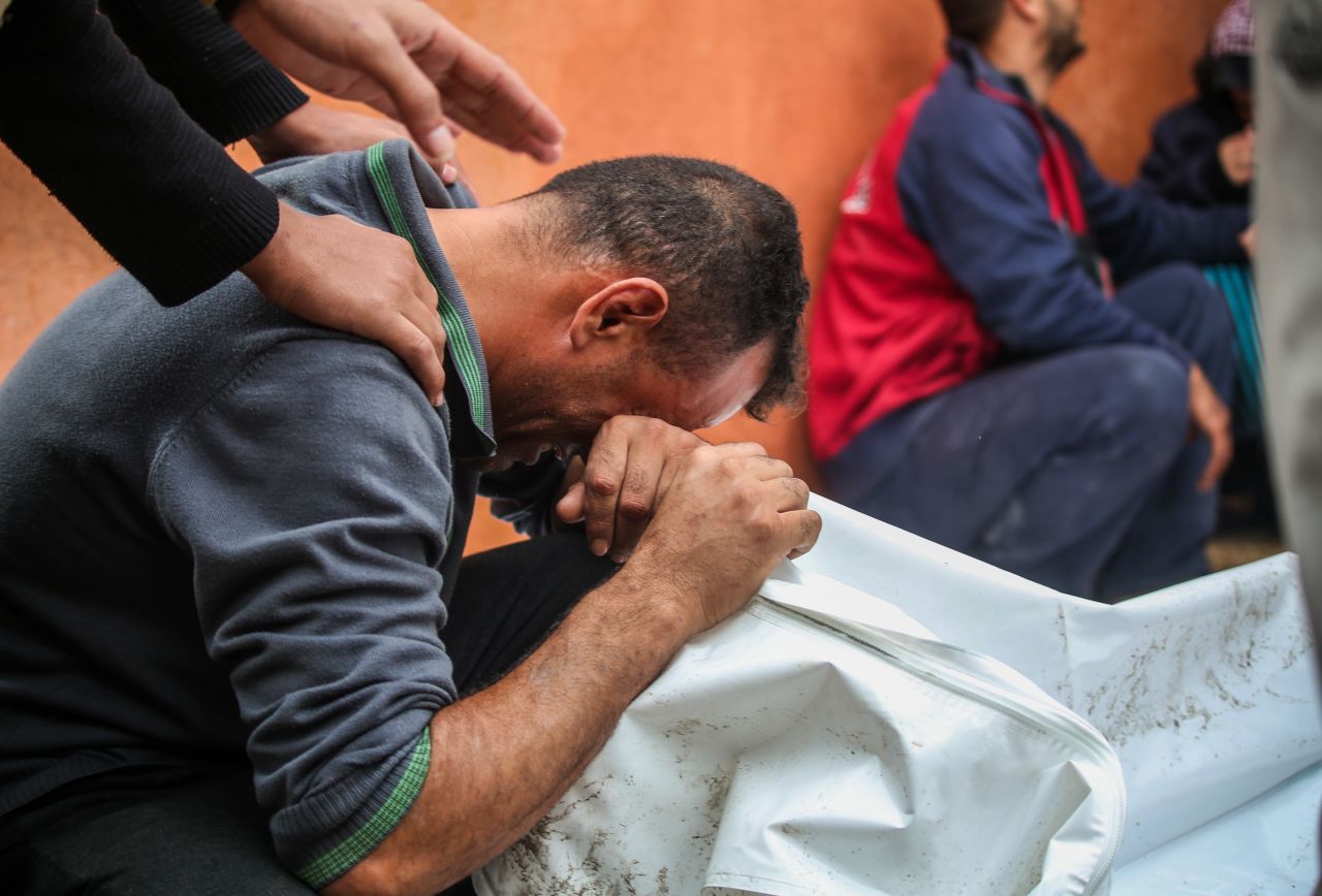 People mourn as they collect the bodies of Palestinians killed in an airstrike on December 13 in Khan Younis, Gaza.