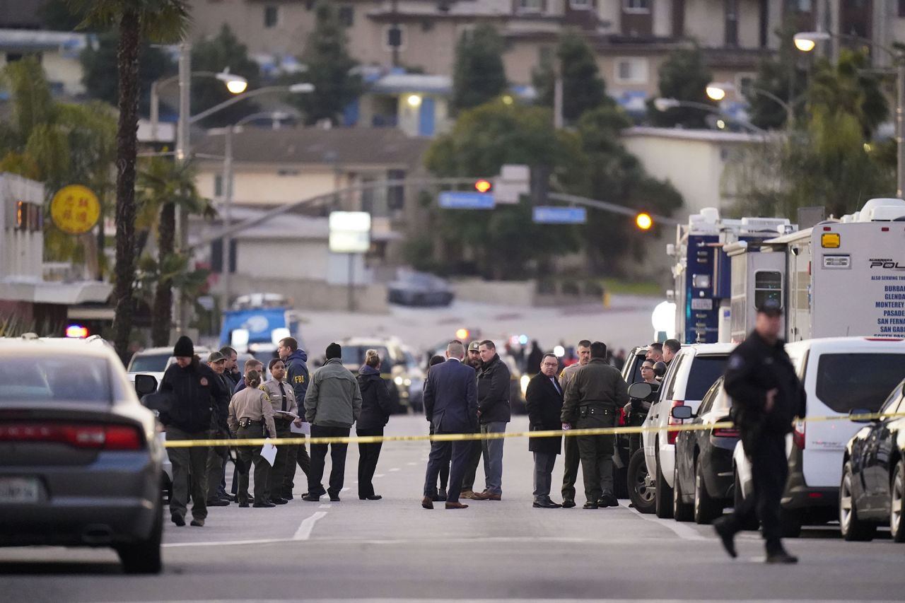 Law enforcement personnel gather near the shooting scene.