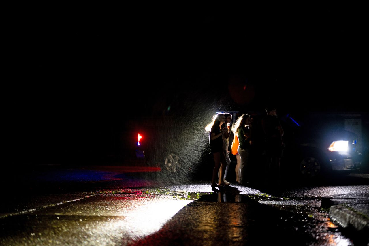 The Brown family speaks with law enforcement after their power went down in the Polk Street neighborhood in Houma, Louisiana, on September 11.