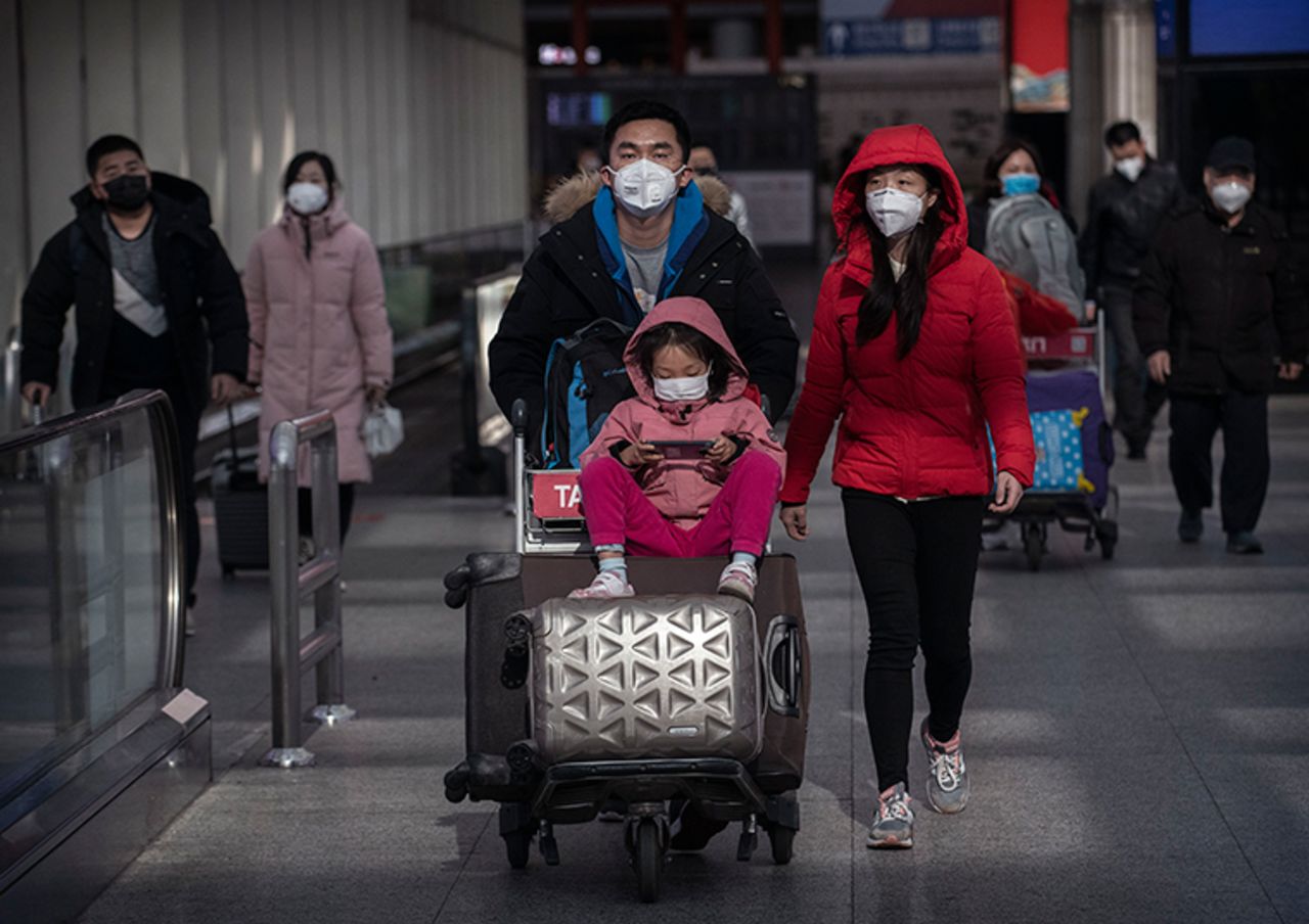 Passengers wear protective masks at Beijing Capital Airport on Thursday, January 30.