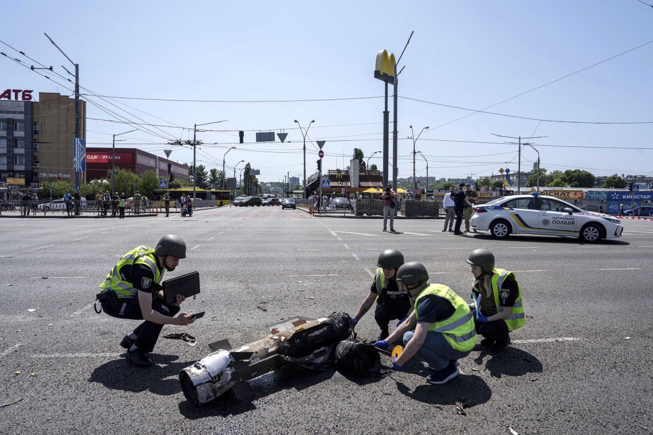 Police officers inspect a fragment of a Russian rocket after an attack in Kyiv, Ukraine, on Monday, May 29. 