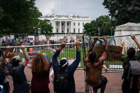Protesters pull down a fence surrounding the statue of Andrew Jackson in Lafayette Square near the White House on June 22 in Washington. 