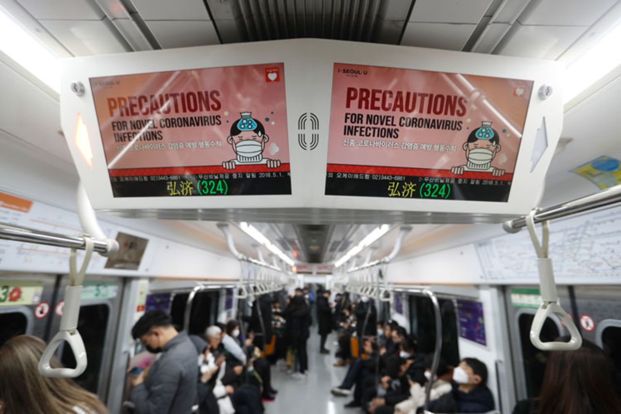 Electric screens announce precautions against the coronavirus on a subway train in Seoul, South Korea, on Monday, February 17.