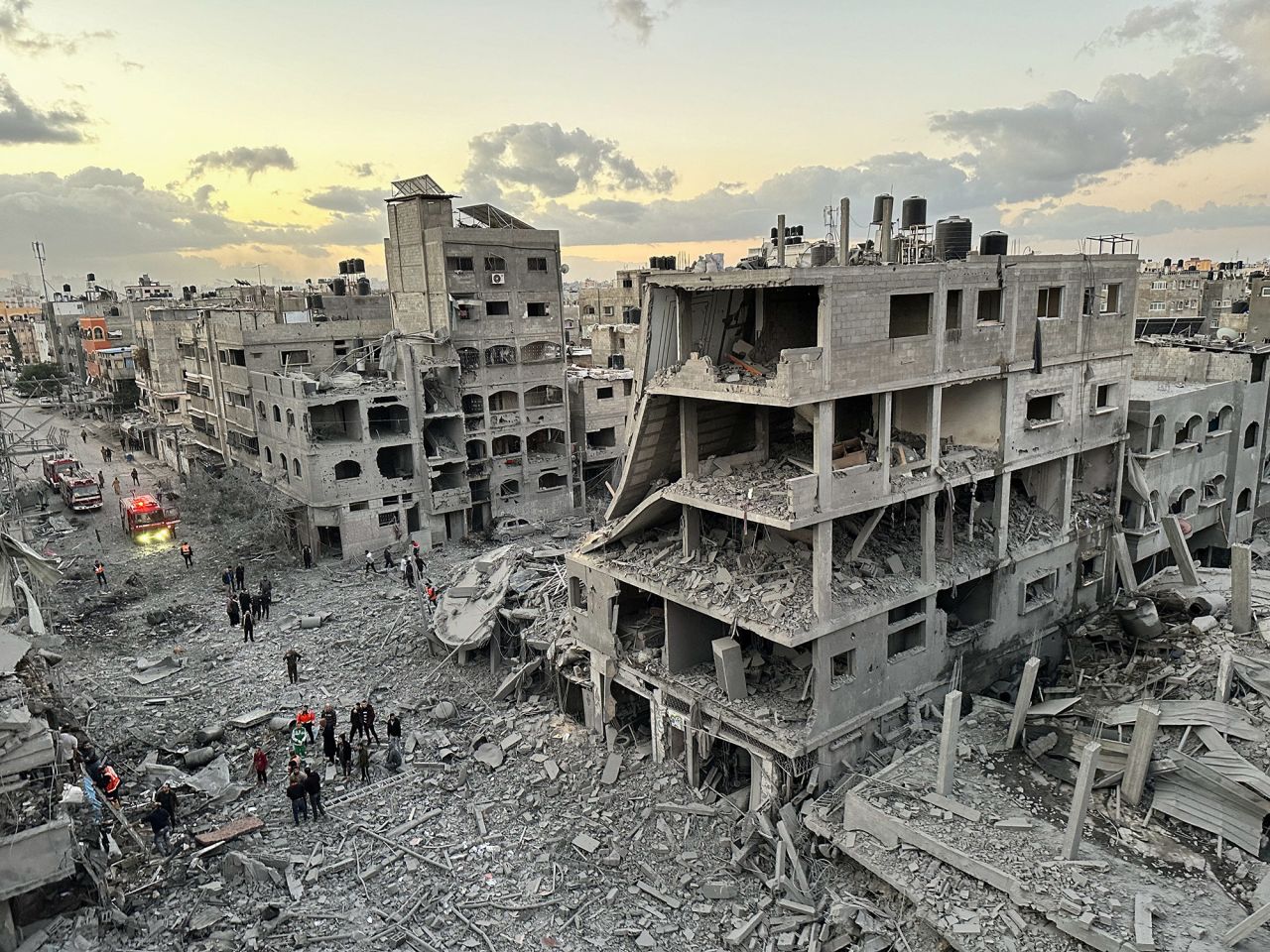 Palestinians walk at the site of Israeli strikes on houses in Jabalya refugee camp, Gaza, on November, 21.