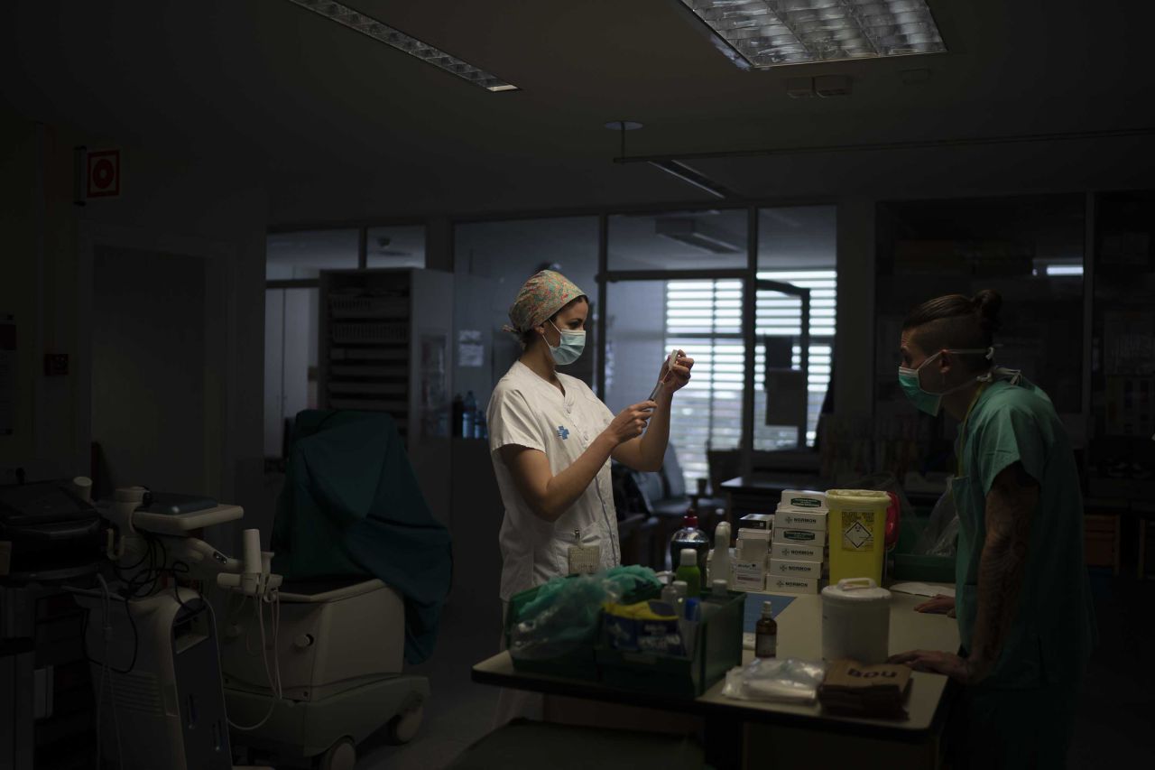 A healthcare worker prepares medication for a coronavirus patient at a hospital in Badalona, Spain, on April 1.