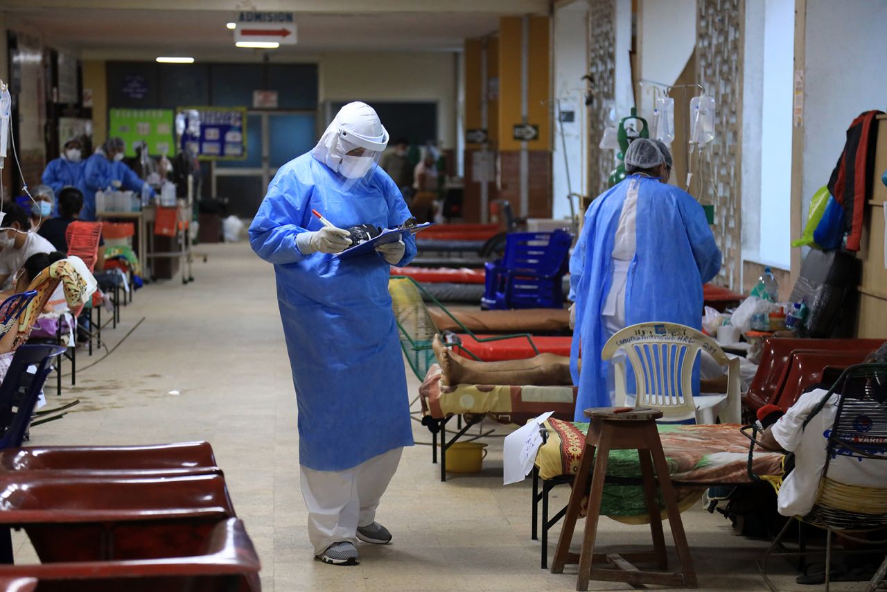 A doctor wearing personal protective gear examines Covid-19 patients at Regional Hospital of Loreto Felipe Arriola Iglesias in Iquitos, Peru, on May 20.