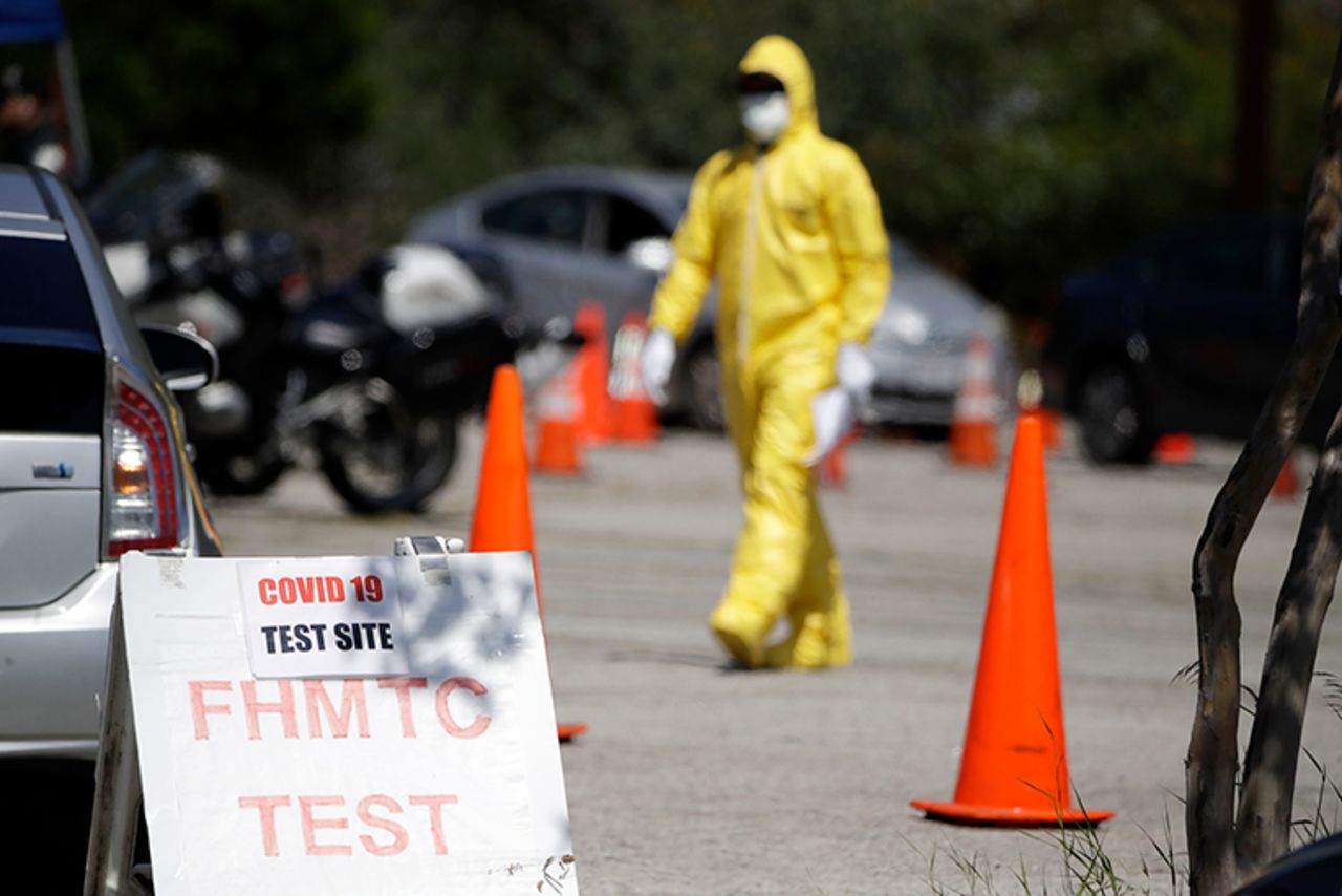 A person wears protective equipment at a coronavirus testing site for first responders on Monday, March 30, in Los Angeles. 