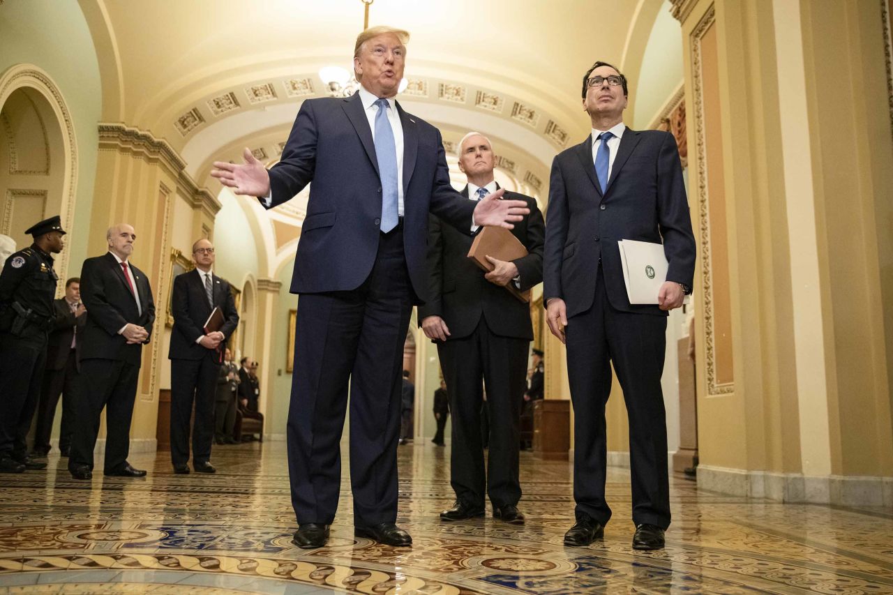 President Trump talks to reporters at the US Capitol alongside Vice President Mike Pence and Treasury Secretary Steve Mnuchin on Tuesday.