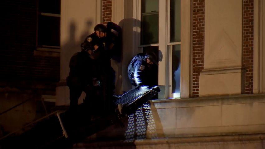 Members of the New York Police Department enter Hamilton Hall on the Columbia University campus on Tuesday evening. 