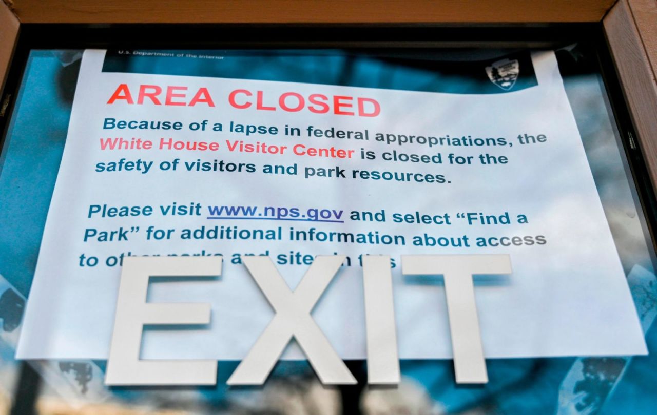 A sign is displayed outside of a US government building December 22. The partial government shutdown is set to stretch through Christmas as the Senate adjourned Saturday without a deal.