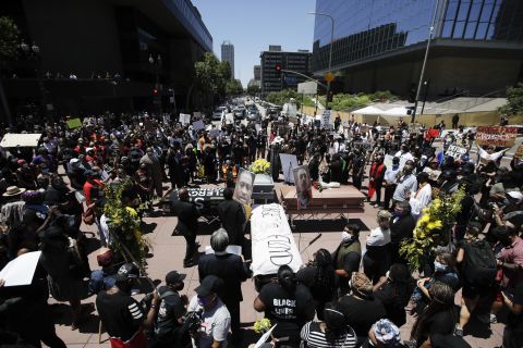 Caskets are laid out in the shape of a cross on June 8, in Los Angeles during a protest over the death of George Floyd.