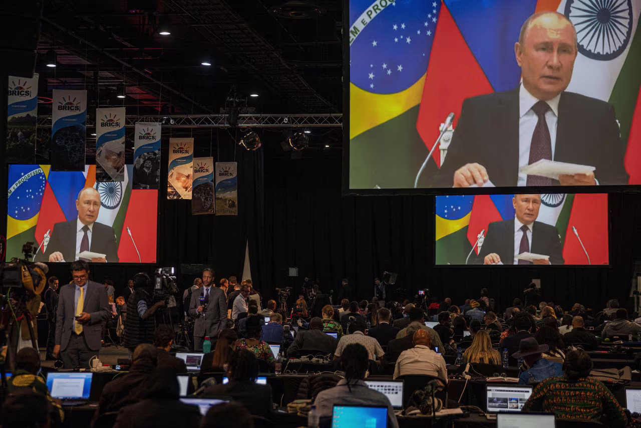 A screen in the media center shows Russian President Vladimir Putin delivering remarks via video-link during the 2023 BRICS Summit at the Sandton Convention Centre in Johannesburg, South Africa, on August 24, 2023.
