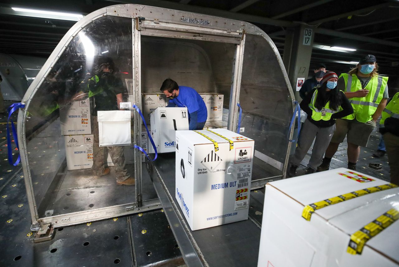 Boxes containing the first shipments of the Pfizer and BioNTech COVID-19 vaccine are unloaded from air shipping containers at UPS Worldport on December 13 in Louisville, Kentucky. 