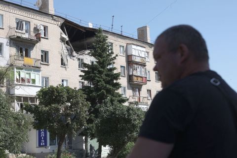 A man walks in front of damaged building in Lysychansk on June 21. 