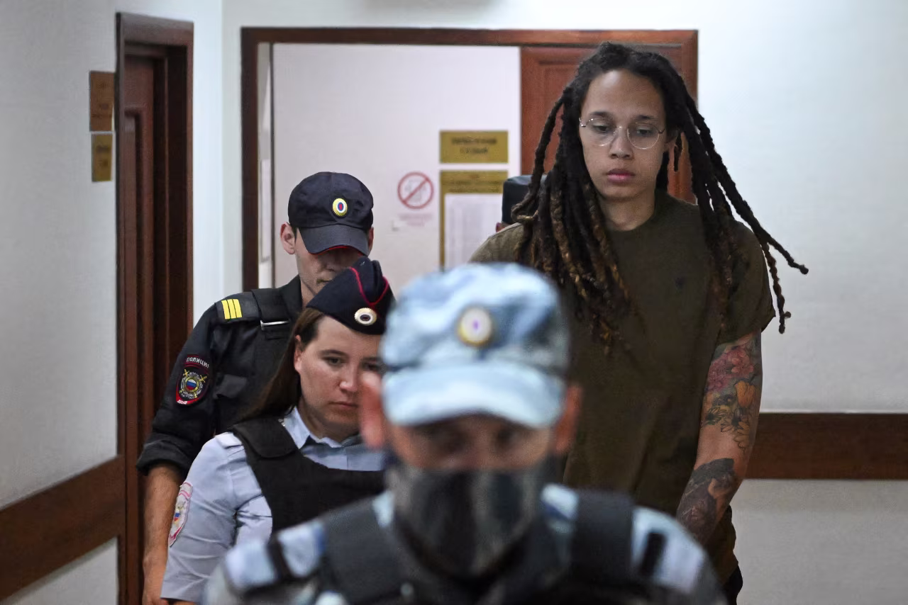 US basketball player Brittney Griner (R) is escorted by police during her trial in Khimki, outside Moscow, Russia, on August 2.