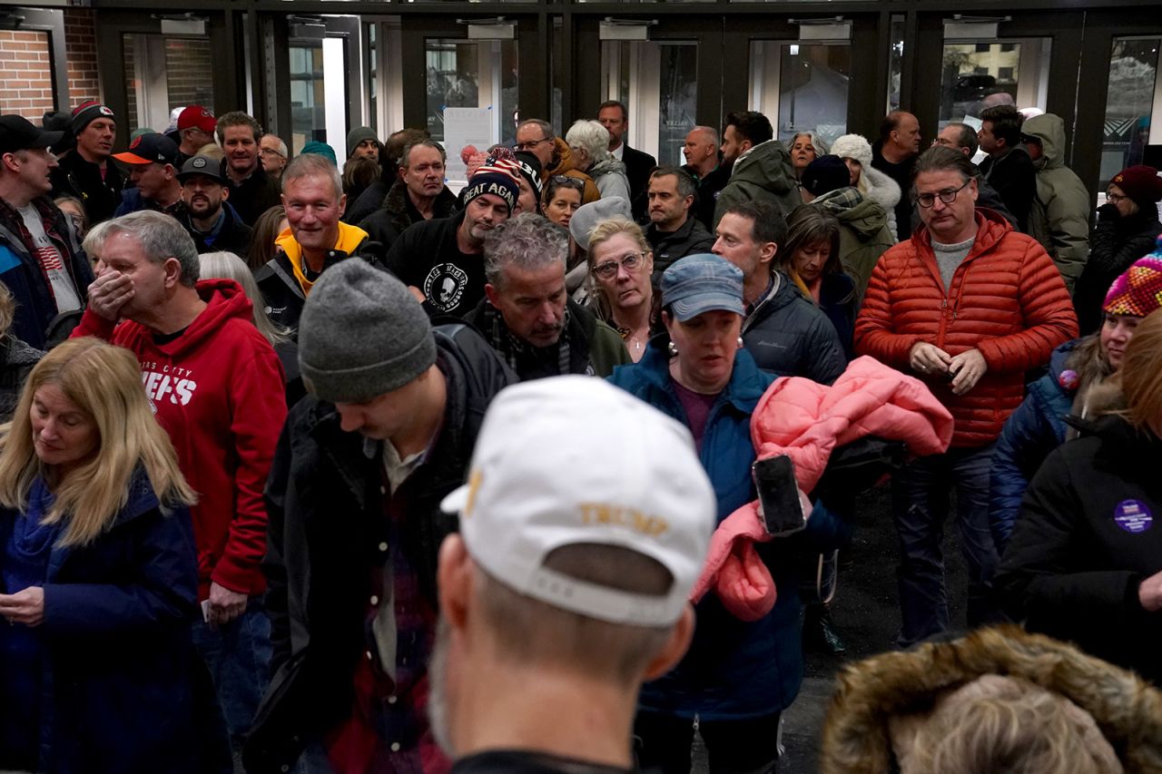 Participants wait in line during the caucuses at Valley High School in West Des Moines, Iowa.