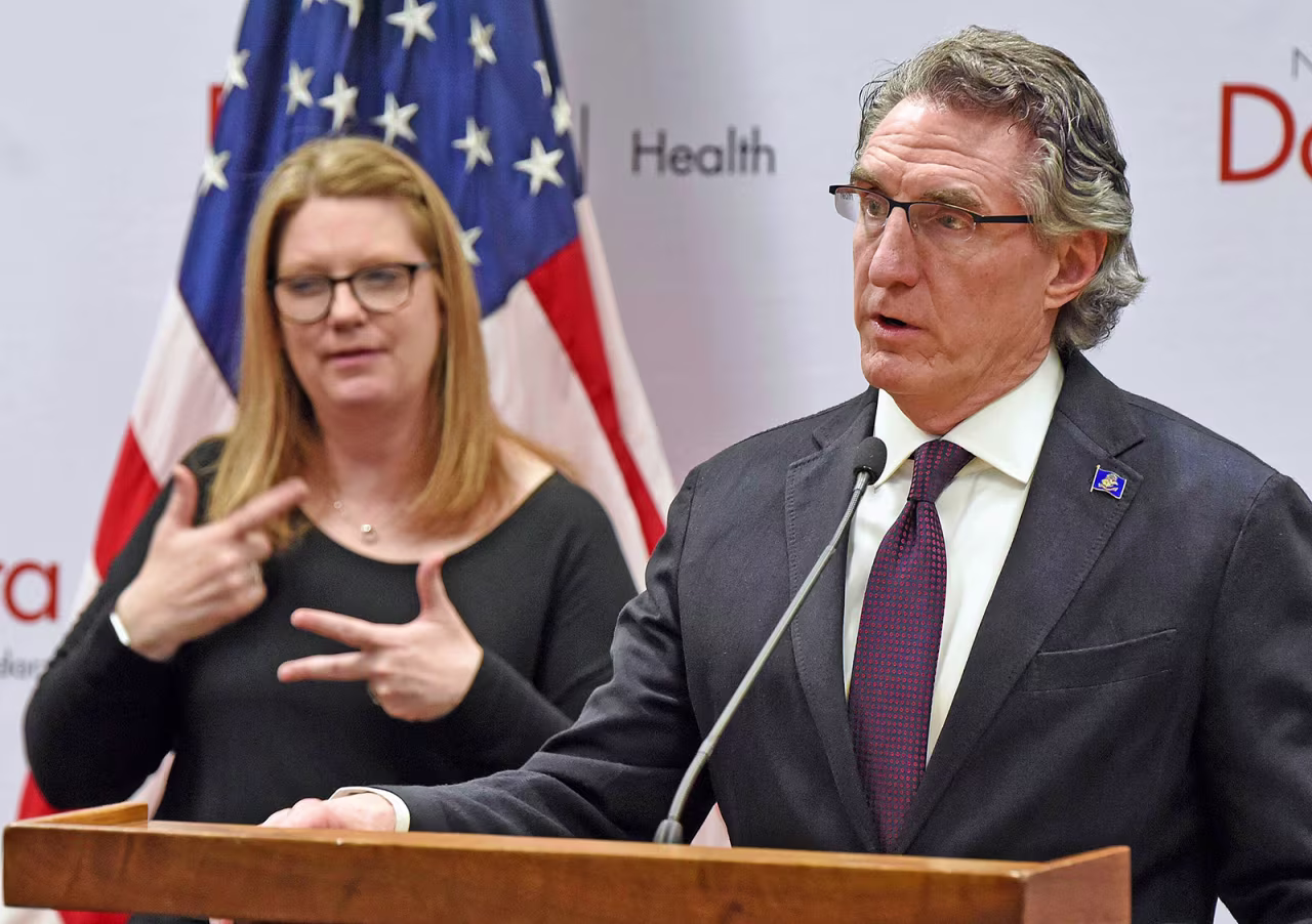 North Dakota Gov. Doug Burgum, right, speaks during a news conference in Bismarck, North Dakota on April 18.