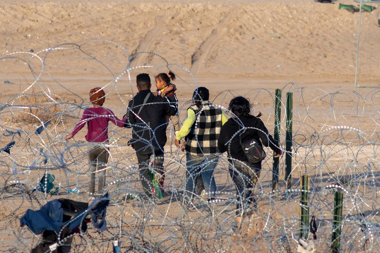 Migrants try to cross along razor wire at the Texas border in Ciudad Juarez, Mexico on January 29.