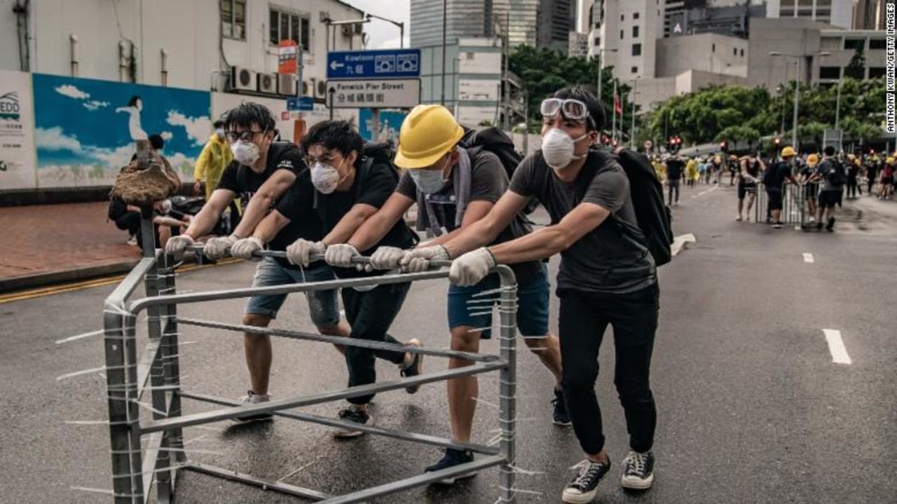 Protesters move barriers into position.