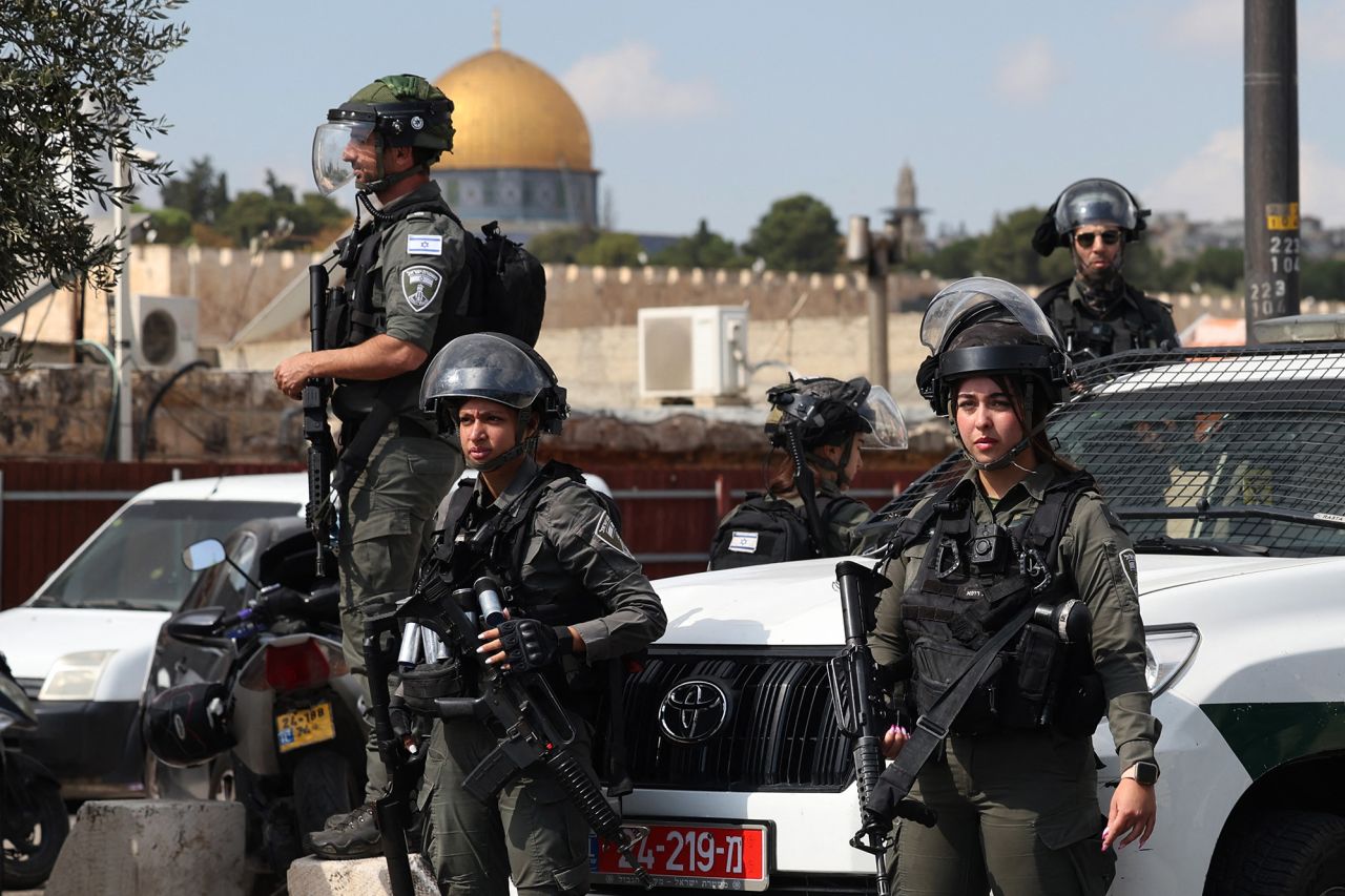 Israeli police look on as Muslim Palestinians take part in Friday Noon prayers in East Jerusalem neighborhood of Ras al-Amud, on October 20.