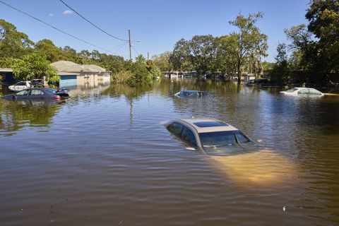 Vehicles and homes are submerged in a flooded neighborhood following Hurricane Ian in Orlando on Friday, September 30. 
