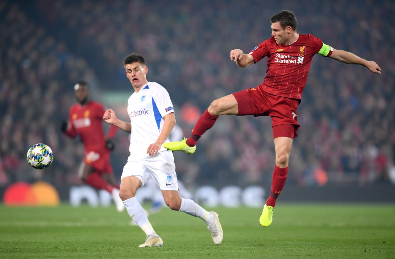 Joakim Maehle of KRC Genk battles for possession with James Milner of Liverpool.