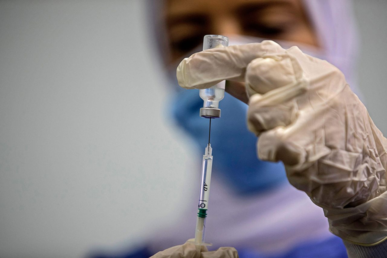 An Egyptian medical worker administers a dose of the Oxford-AstraZeneca Covid-19 vaccine on March 4, 2021 in Cairo on the first day of vaccination in Egypt.