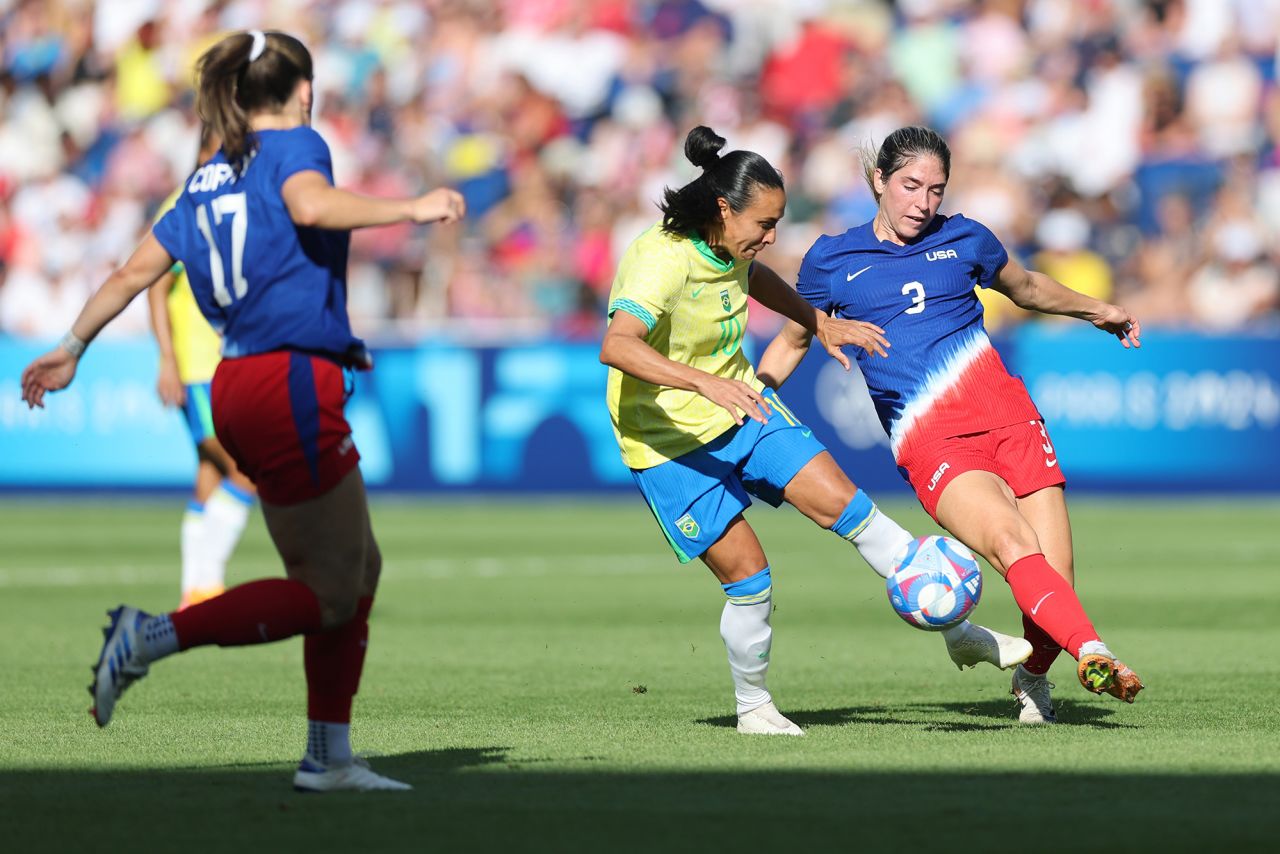 Brazil’s Marta, center, battles for the ball during the women's soccer gold medal match against the US on August 10. 