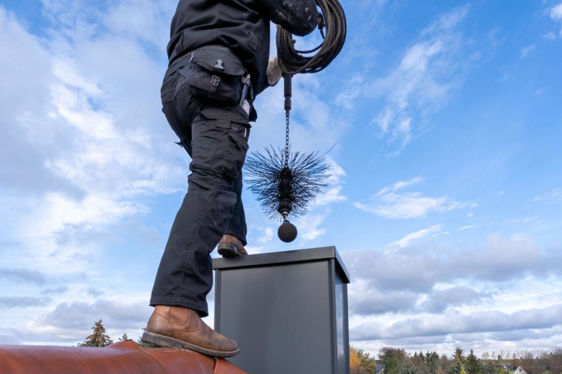 Chimney sweep cleaning out the chimney