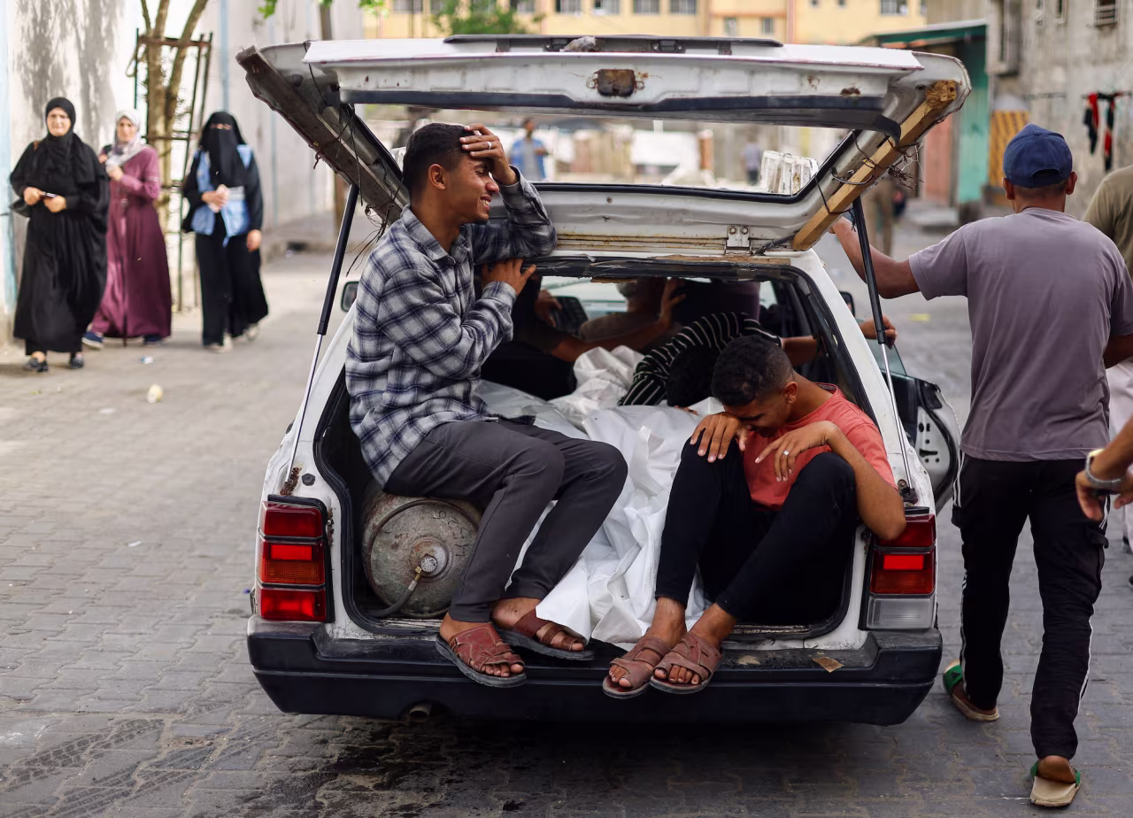 Mourners are seen in a vehicle next to the bodies of Palestinians killed in an Israeli strike in Rafah on Monday.