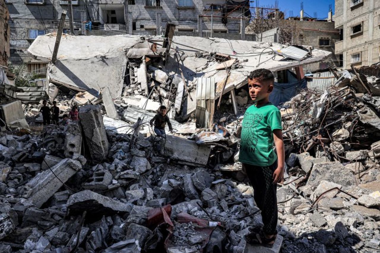 A boy stands by the rubble of a collapsed building in Rafah, Gaza, on April 9.