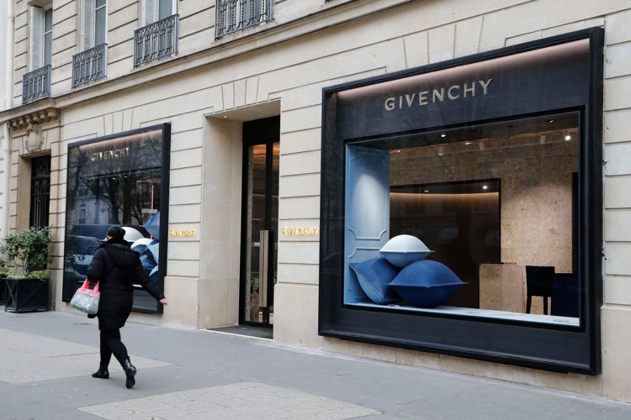 A pedestrian walks past a Givenchy shop closed due to the spread of the coronavirus on March 16 in Paris. 