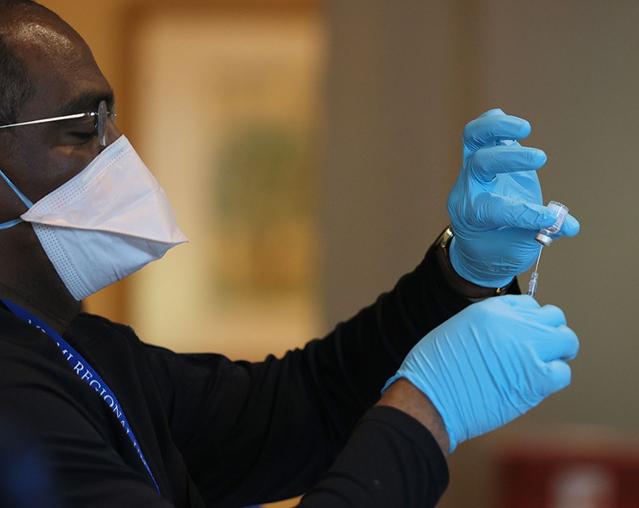 A healthcare worker prepares a dose of the Pfizer-BioNtech COVID-19 vaccine in Pompano Beach, Florida.