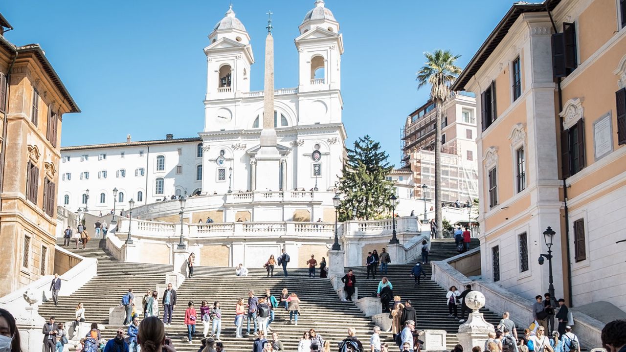 Tourists wearing facial masks visit the historic centre of Rome on February 24.