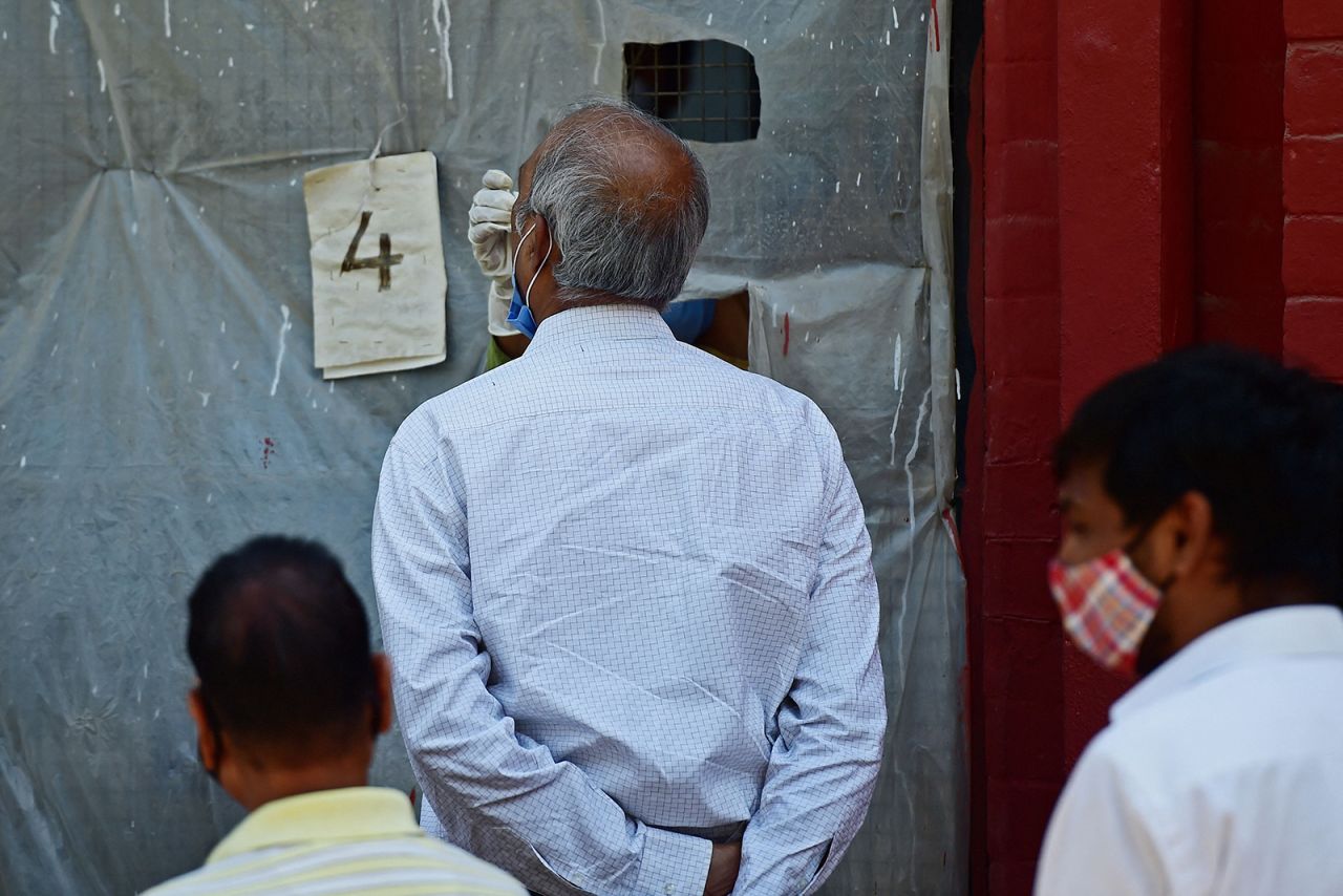 A health official takes a swab sample from a man to test for Covid-19 at a testing centre in Allahabad, India, on April 12.