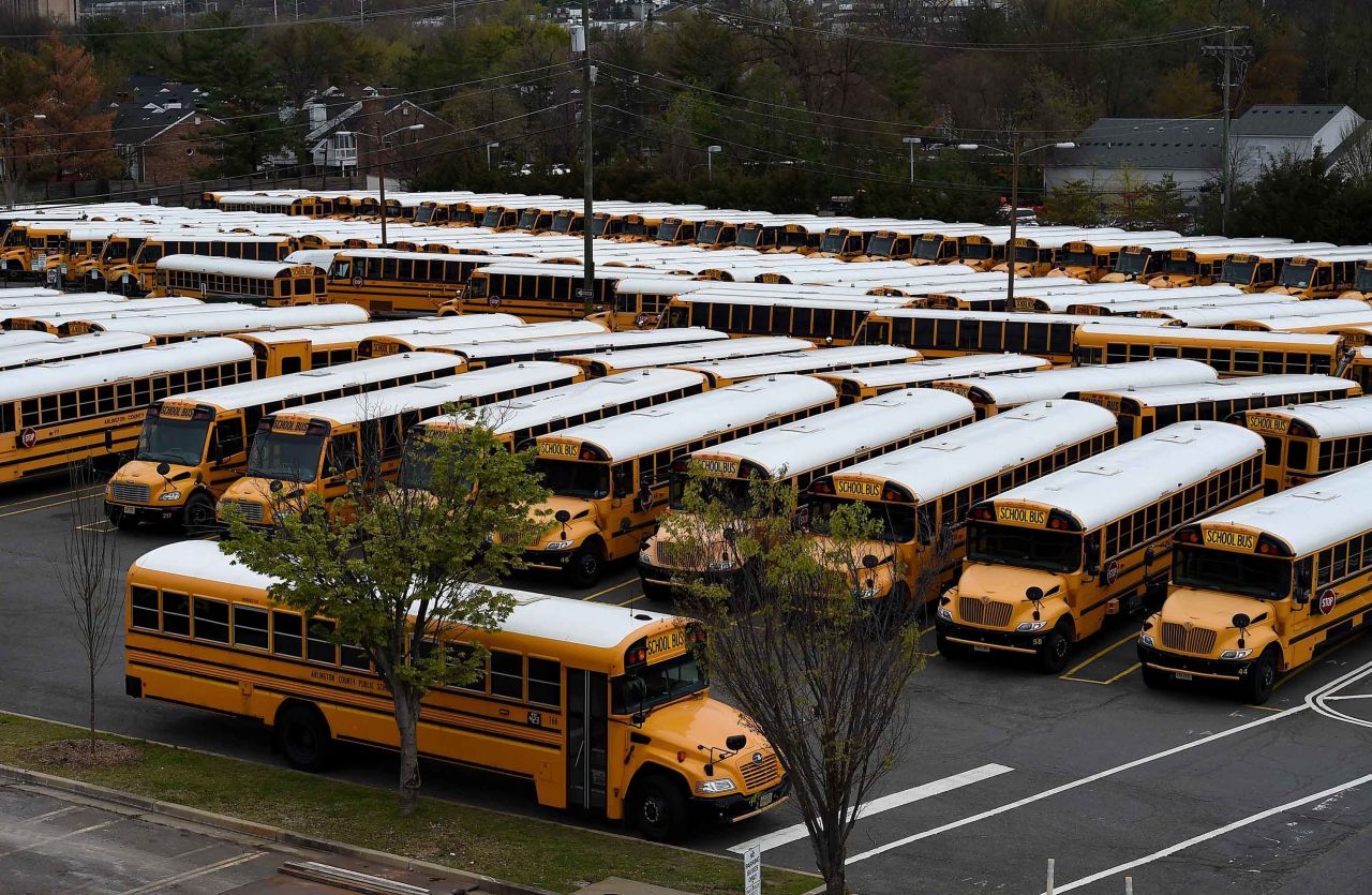 School buses are parked at the Arlington County Bus Depot in Arlington, Virginia, on March 31.