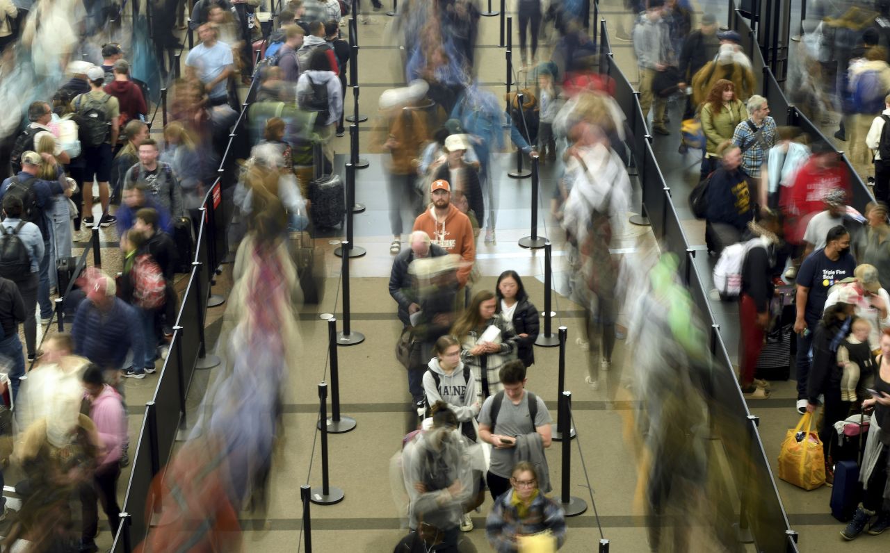Travelers wait in a security line at Denver International Airport on Tuesday.