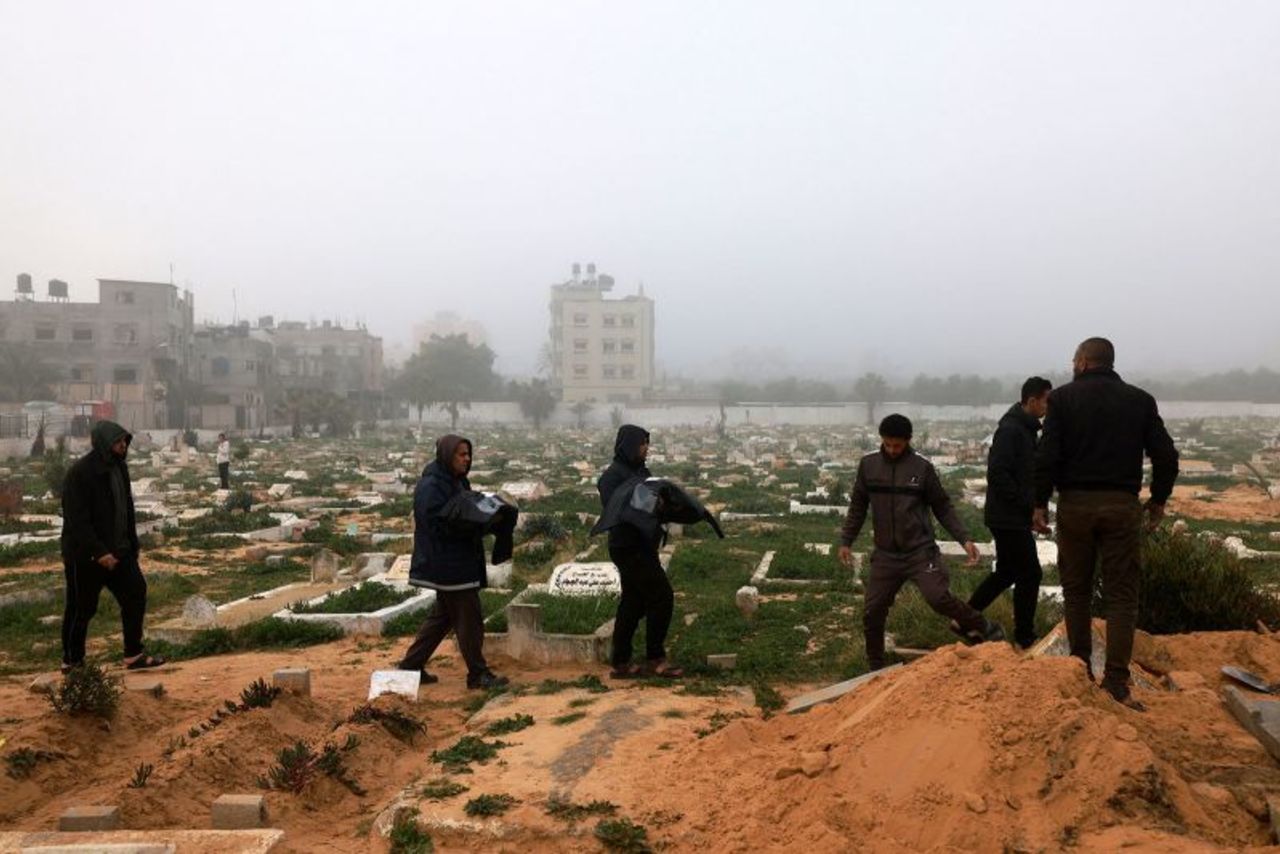 Mourners carry the bodies of children, who were killed in a strike in Rafah, during their funeral on February 9.