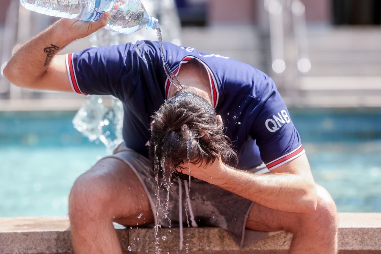 A young man pours water over himself to combat the heat on July 12 in Madrid, Spain.