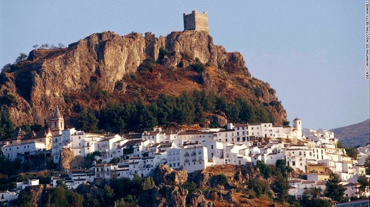 Zahara de la Sierra and its castle perch on a hilltop in Andalusia, Spain.